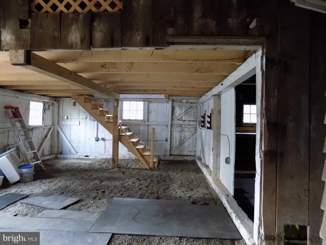 a view of a room with wooden stairs