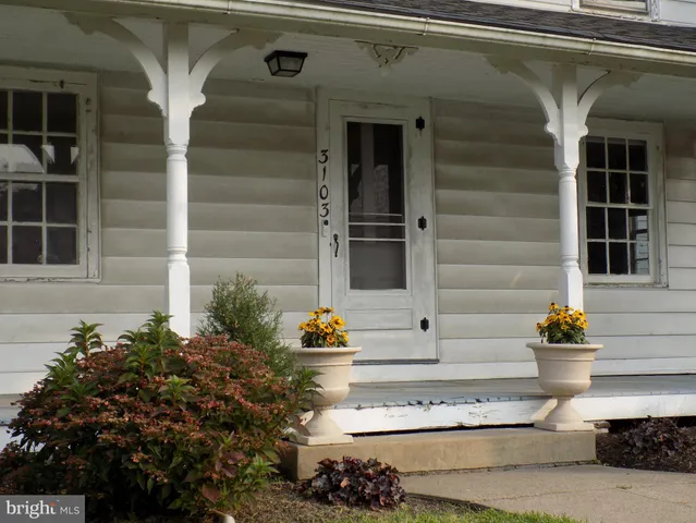a front view of a house with outdoor seating and plants