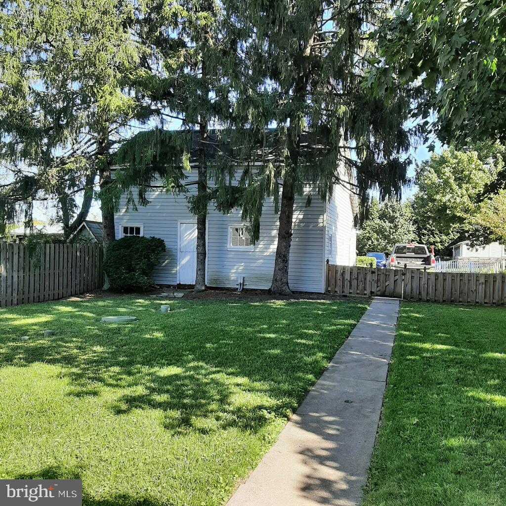 3103 Bedminster Road Ottsville, PA 18942 - Photo 4 of 22 a view of a backyard with large trees and wooden fence