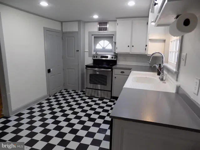 a kitchen with a sink and a refrigerator
