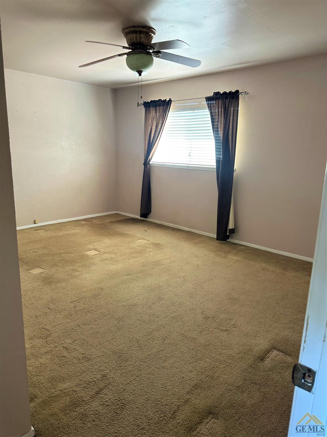 Undisclosed Address Bakersfield, CA 93313 - Photo 17 of 30 a view of an empty room with a window