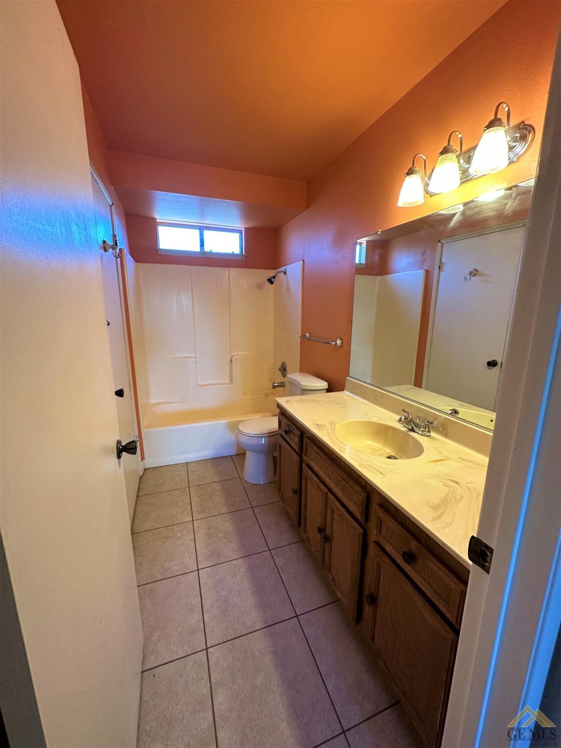 Undisclosed Address Bakersfield, CA 93313 - Photo 20 of 30 a bathroom with a granite countertop sink and a mirror