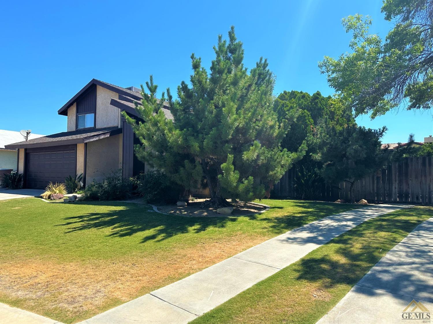 Undisclosed Address Bakersfield, CA 93313 - Photo 2 of 30 a view of a backyard with plants and large trees