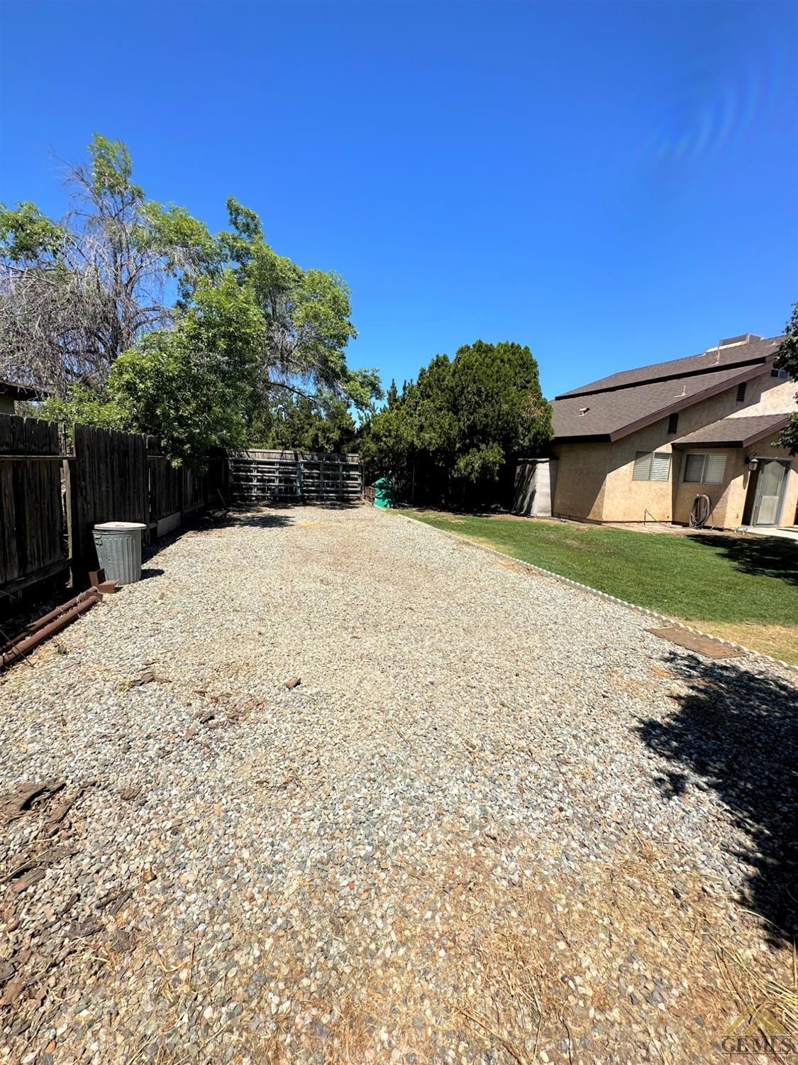 Undisclosed Address Bakersfield, CA 93313 - Photo 25 of 30 a view of white house with a yard