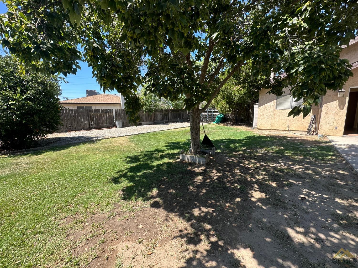 Undisclosed Address Bakersfield, CA 93313 - Photo 26 of 30 a backyard of a house with lots of green space