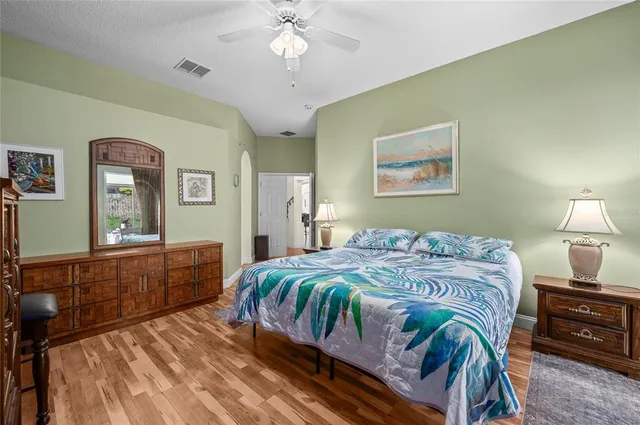 a bathroom with a tub a sink double vanity and a mirror