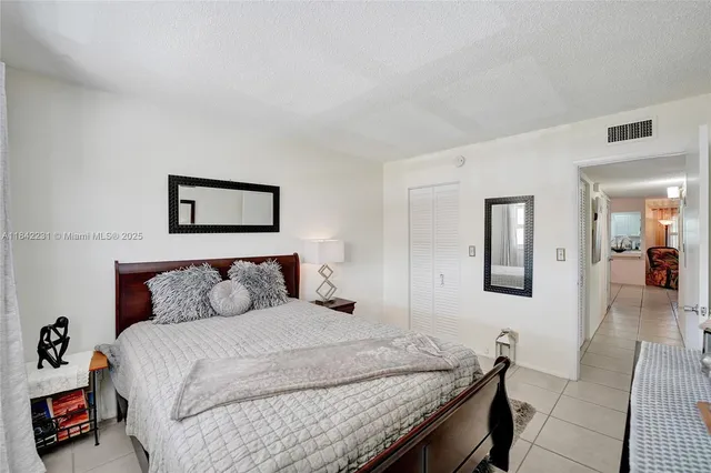 a bathroom with a sink a toilet a mirror and shower curtain