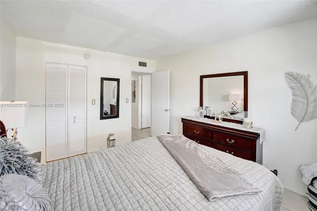 a bathroom with a granite countertop sink a toilet a mirror and shower