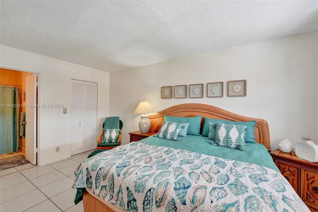 a living room with patio furniture and a potted plants