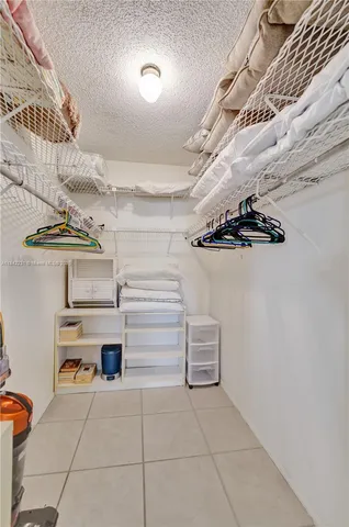 a view of building with cars parked in front of it