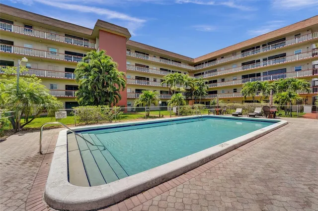 a view of a swimming pool with a yard
