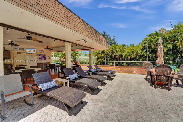 a view of a patio with table and chairs and potted plants