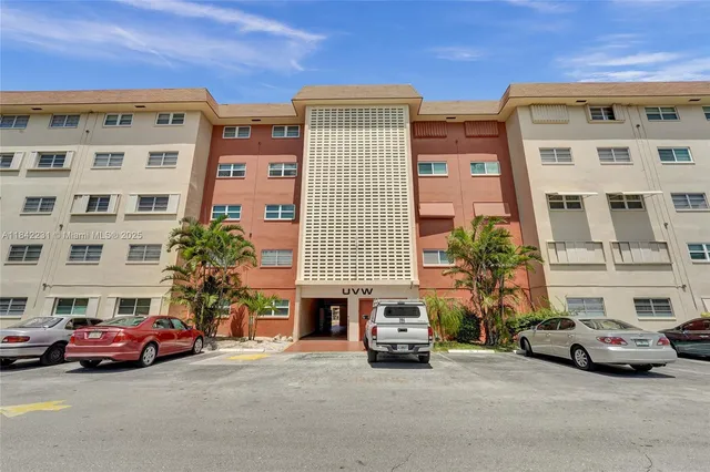 a kitchen with a refrigerator a sink and cabinets