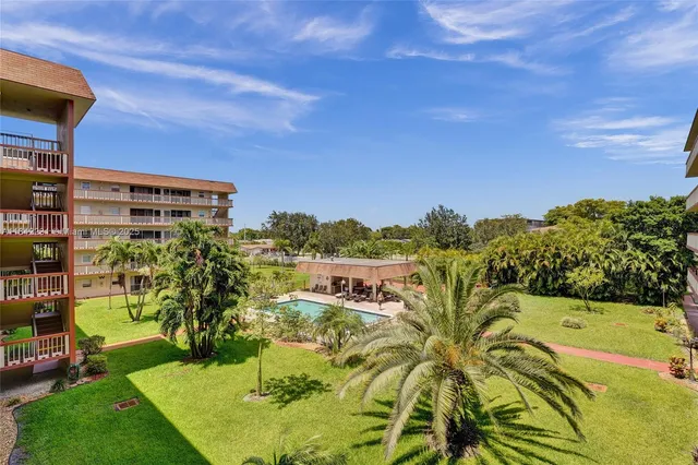 a living room with lots of furniture and a kitchen view