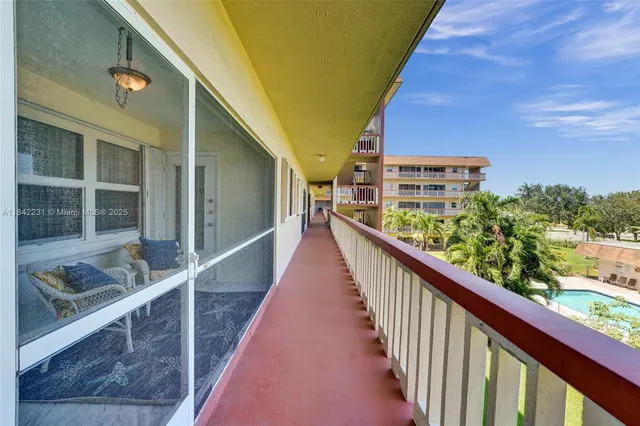 a room with pool table and windows