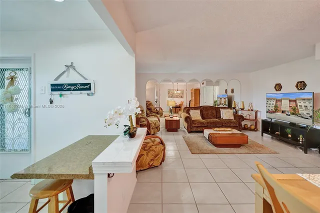 a living room with furniture a couch and a window