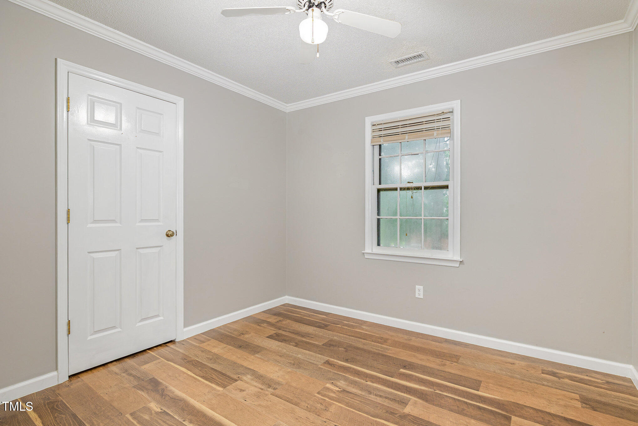 19 Eden Drive Smithfield, NC 27577 - Photo 28 of 37 a view of empty room with wooden floor and fan