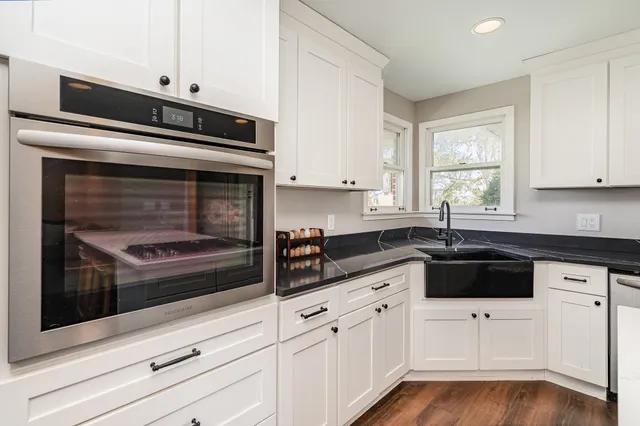 a kitchen with stainless steel appliances kitchen island granite countertop a refrigerator and a stove top oven