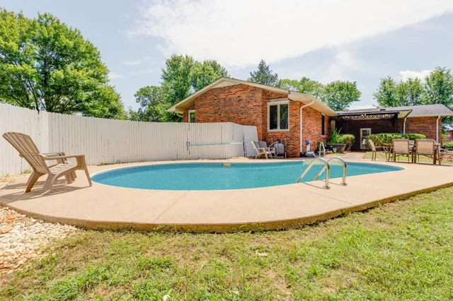 an aerial view of a house with a yard basket ball court and outdoor seating