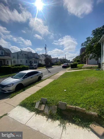 a view of a street with cars parked