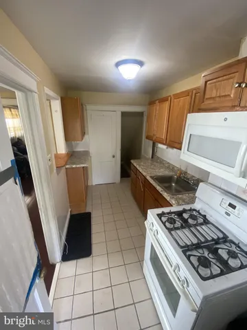 a kitchen with a stove a refrigerator and a sink
