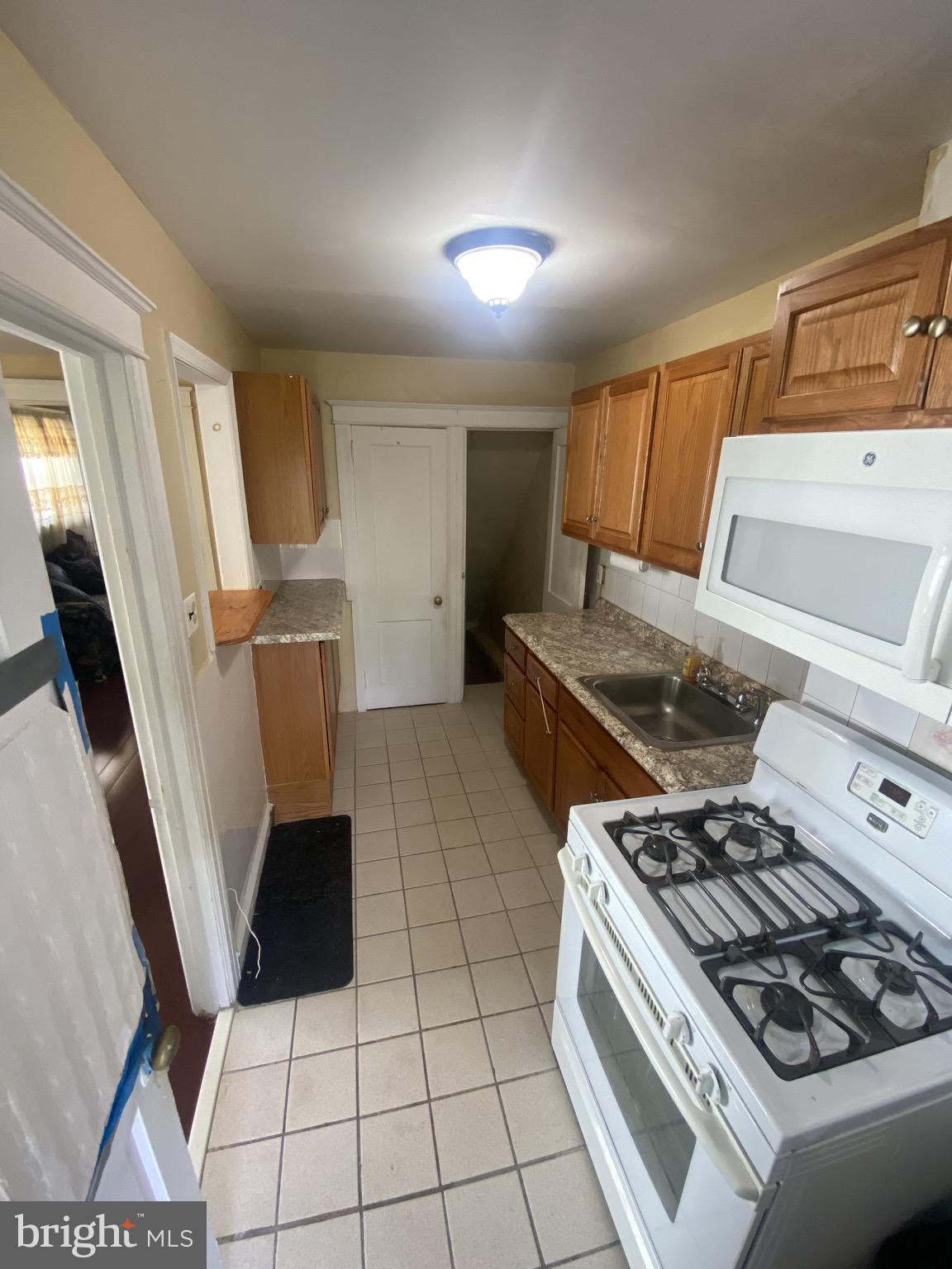 536 Cypress Street Lansdowne, PA 19050 - Photo 8 of 22 a kitchen with a stove a refrigerator and a sink