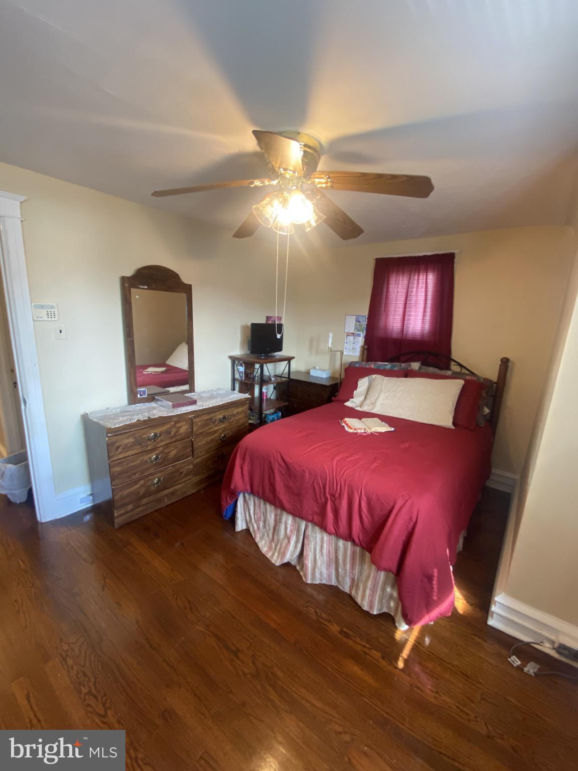 536 Cypress Street Lansdowne, PA 19050 - Photo 9 of 22 a bedroom with a bed and a chandelier