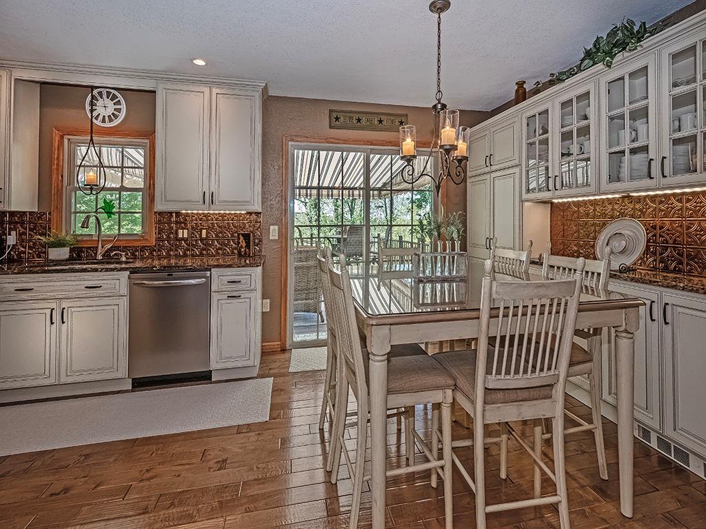 638 Knoll Lane Apollo, PA 15613 - Photo 7 of 30 a kitchen with stainless steel appliances granite countertop a stove top oven a sink a dining table and chairs