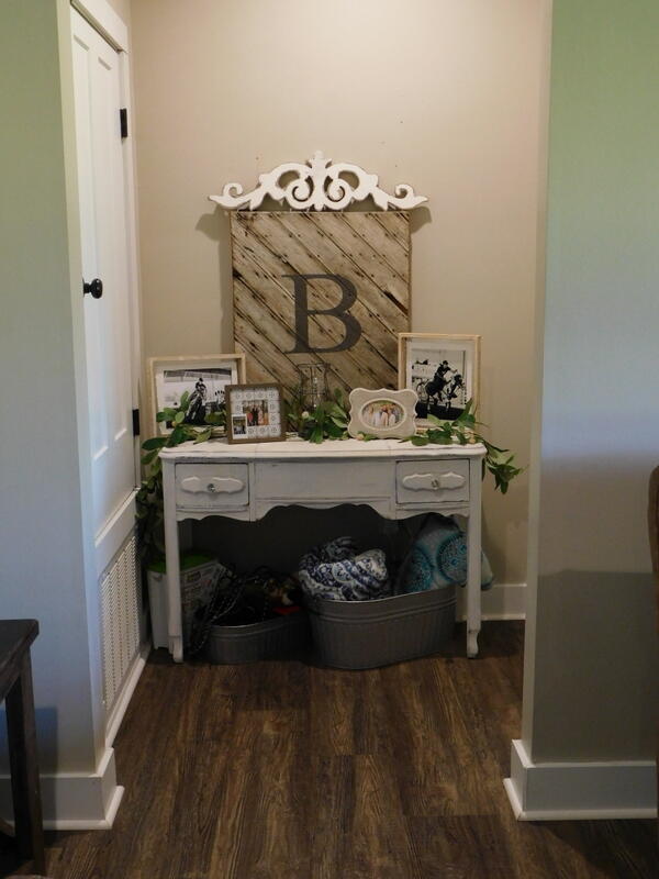 5856 Bush Road Baker, FL 32531 - Photo 22 of 57 a bed sitting in a bedroom next to a bathroom sink with vanity and mirror