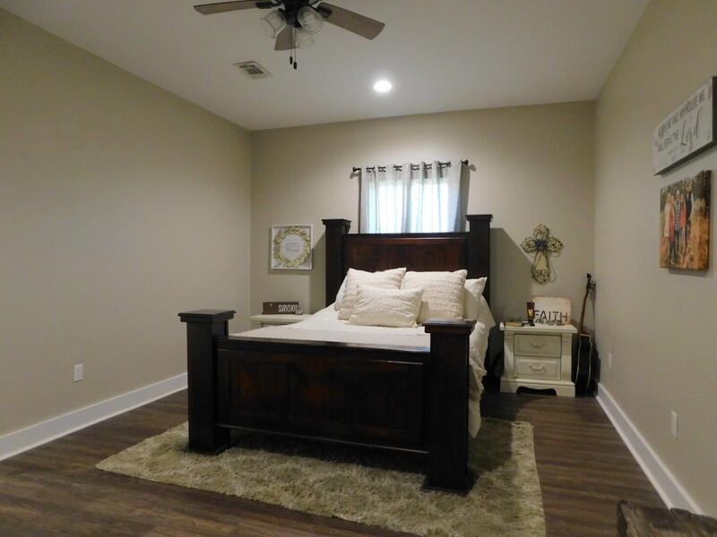 5856 Bush Road Baker, FL 32531 - Photo 24 of 57 a bedroom with a bed and wooden floor