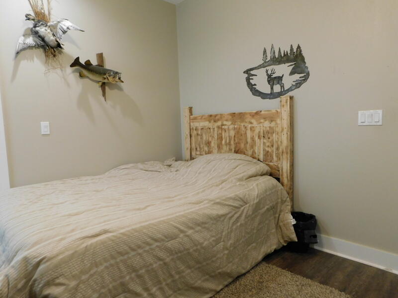 5856 Bush Road Baker, FL 32531 - Photo 32 of 57 a bedroom with a bed and a chandelier