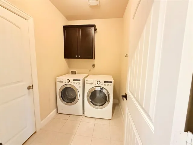 a living room with furniture a flat screen tv and a window