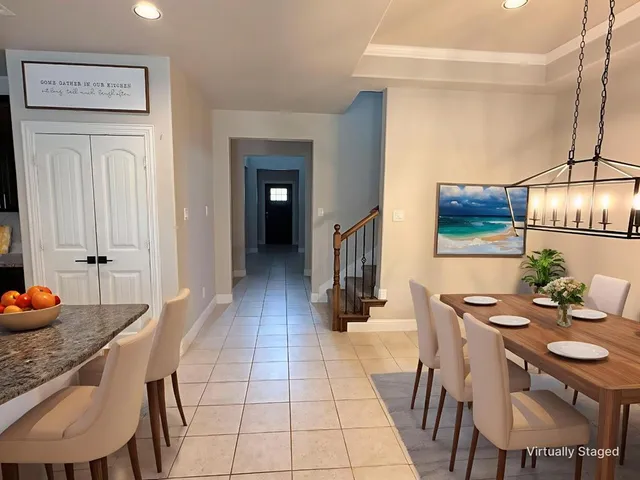 a kitchen with stainless steel appliances granite countertop a sink refrigerator and cabinets