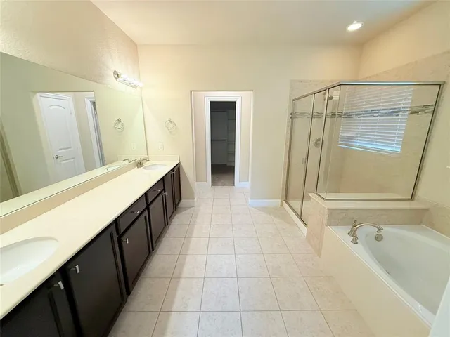 a spacious bedroom with a bed and a large window