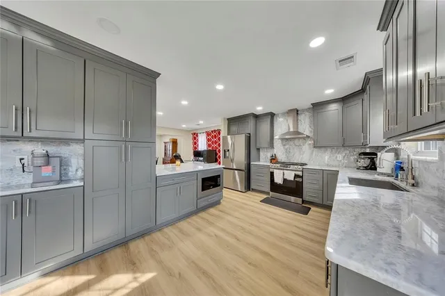 a kitchen with stainless steel appliances granite countertop a refrigerator sink and cabinets