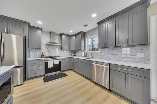 a kitchen with stainless steel appliances granite countertop a refrigerator sink and cabinets