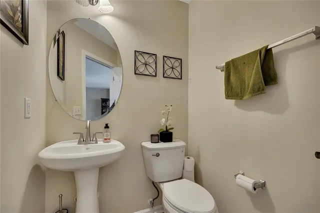 a bathroom with a sink mirror and toilet