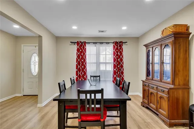 a living room with furniture stairs and a wooden floor