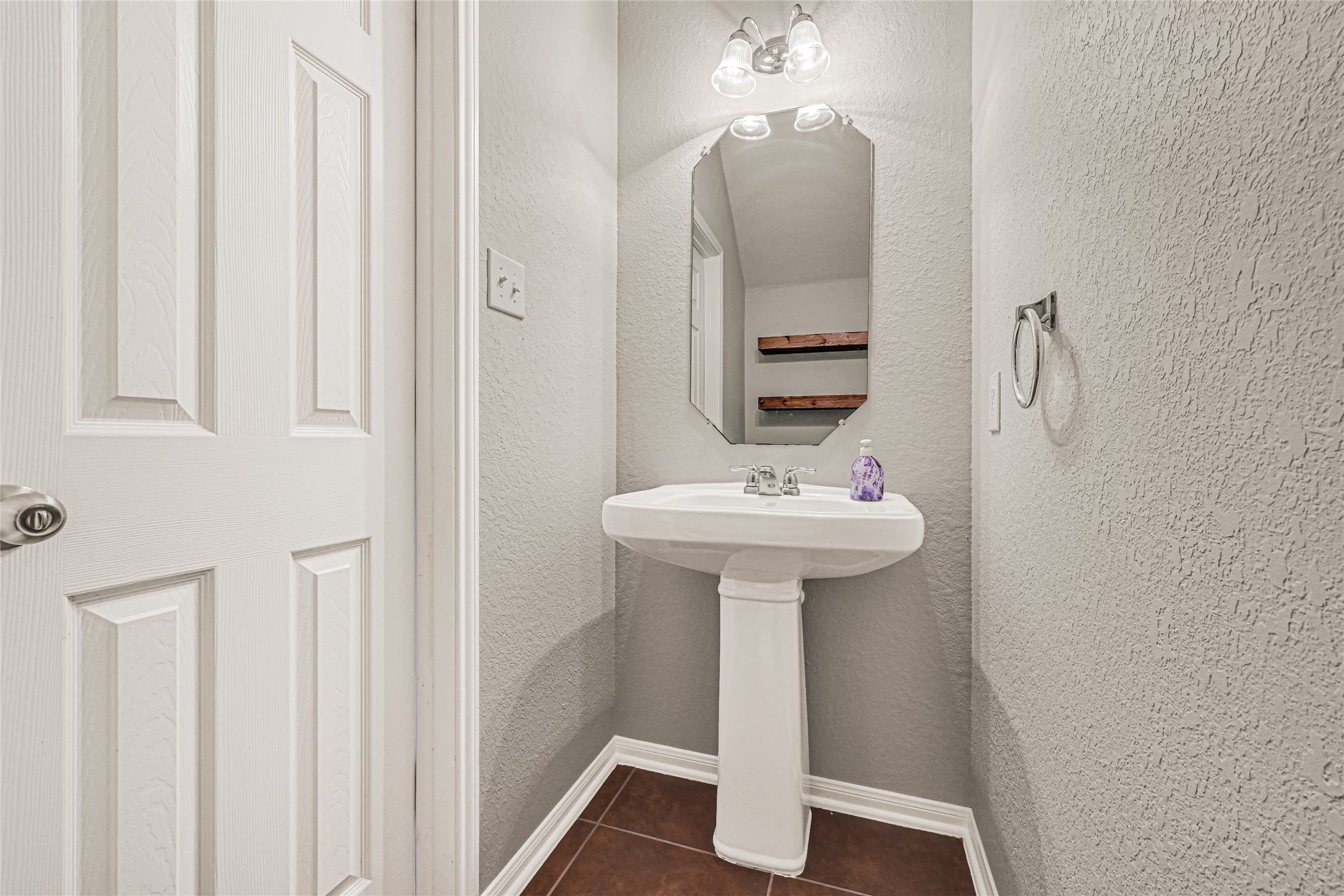 5331 Seabird Street Baytown, TX 77521 - Photo 16 of 38 a bathroom with a sink a mirror and toilet