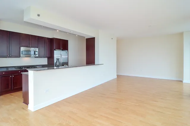 a kitchen with cabinets and a window