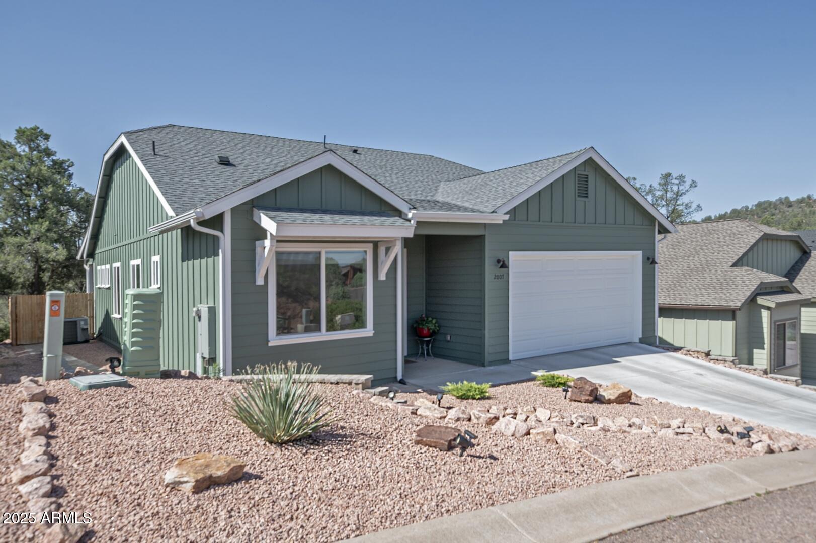 2007 East Rainbow Trail Payson, AZ 85541 - Photo 1 of 34 a front view of a house with a yard and garage