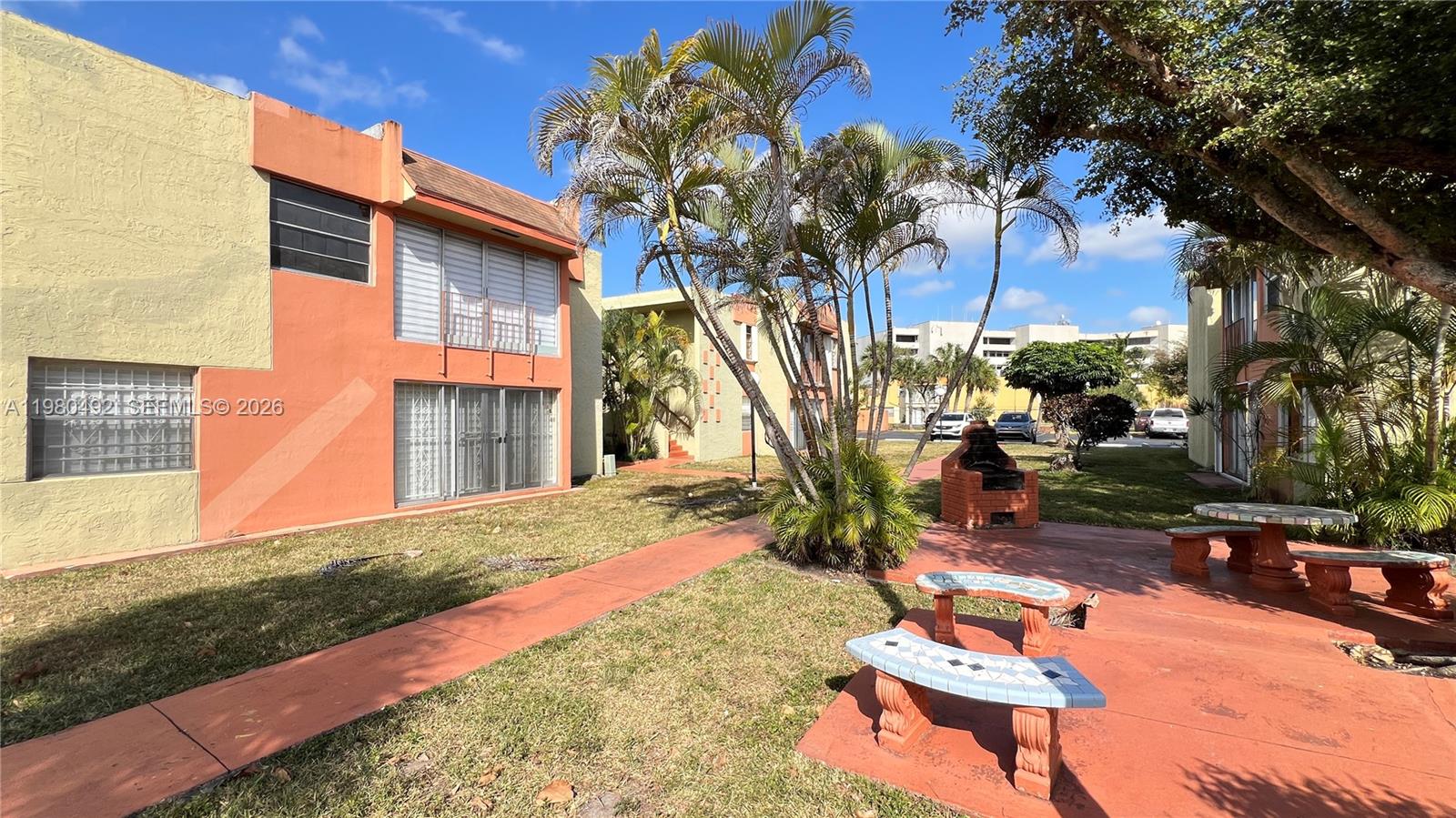 9331 Southwest 4th Street, Unit 101A Miami, FL 33174 - Photo 14 of 15 a backyard of a house with outdoor seating