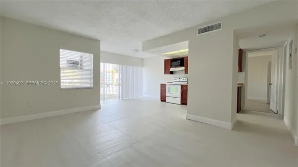 a view of an empty room with a window