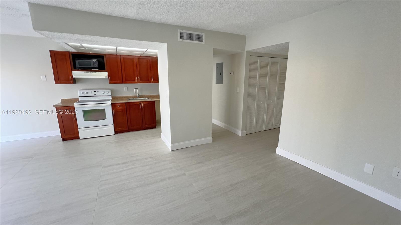 9331 Southwest 4th Street, Unit 101A Miami, FL 33174 - Photo 5 of 15 a view of kitchen with stainless steel appliances wooden floor and window