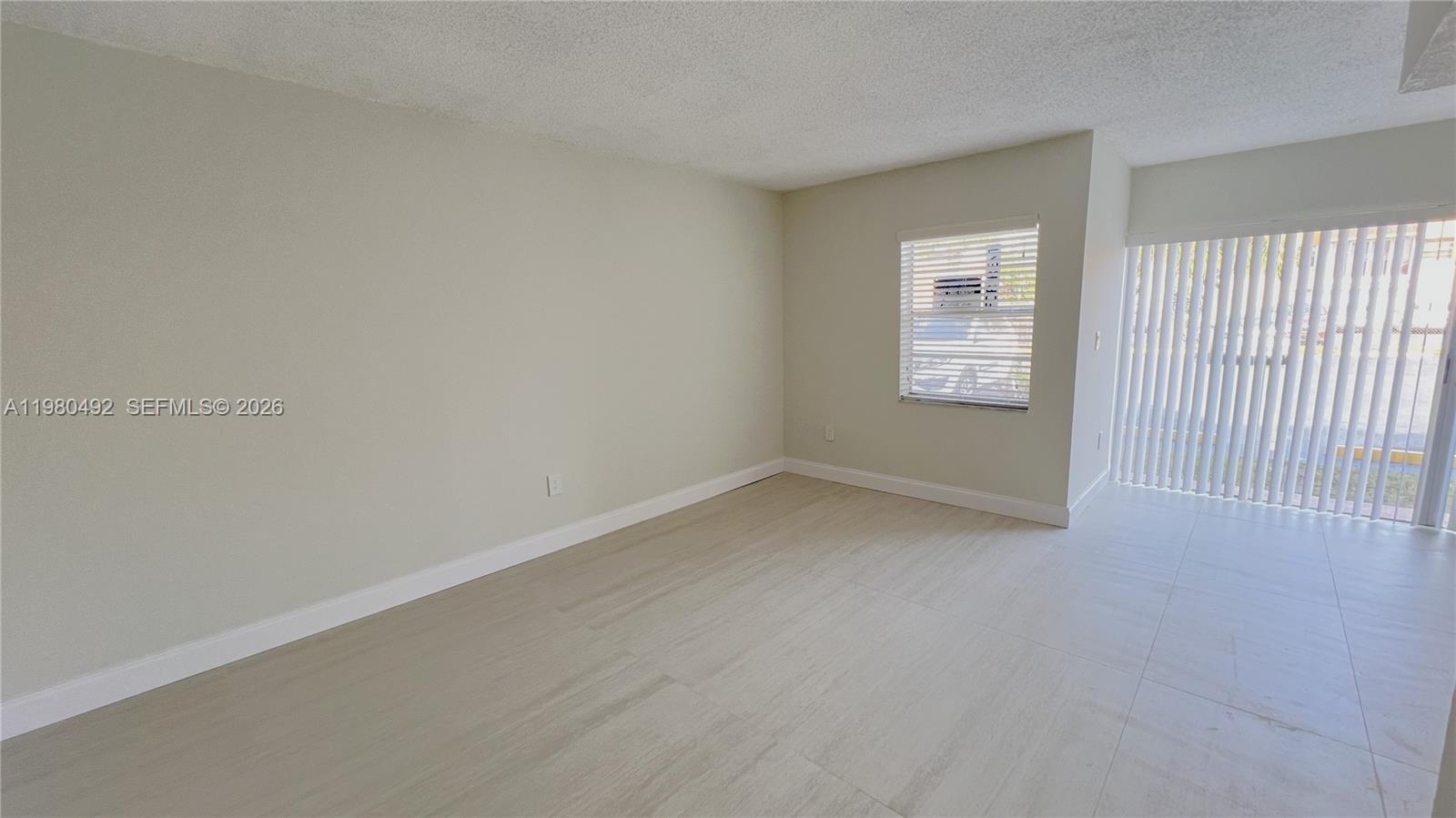 9331 Southwest 4th Street, Unit 101A Miami, FL 33174 - Photo 8 of 15 an empty room with a window
