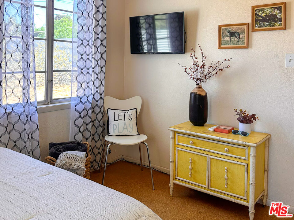 61855 Valley View Circle Joshua Tree, CA 92252 - Photo 29 of 59 a bedroom with a bed and wooden floor