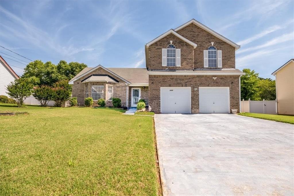 4586 Osprey Lane Decatur, GA 30035 - Photo 1 of 1 a front view of a house with a yard and garage