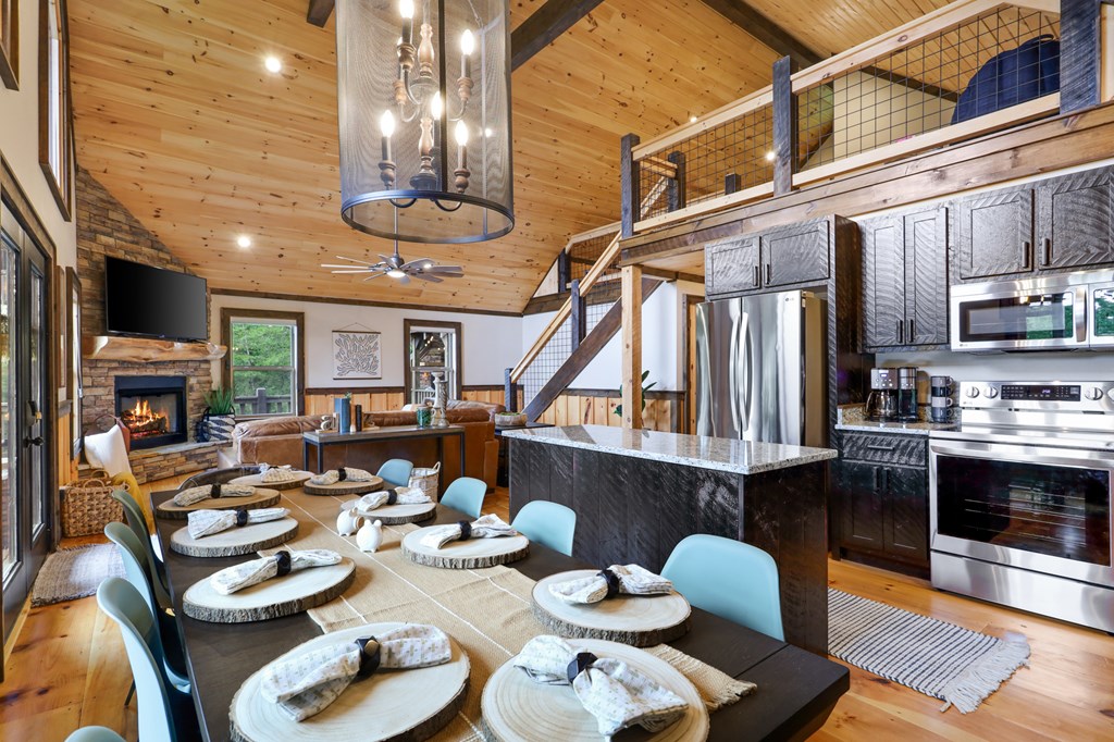 42 Old Jerusalem Road Morganton, GA 30560 - Photo 13 of 61 a view of a dining room with furniture a kitchen and chandelier