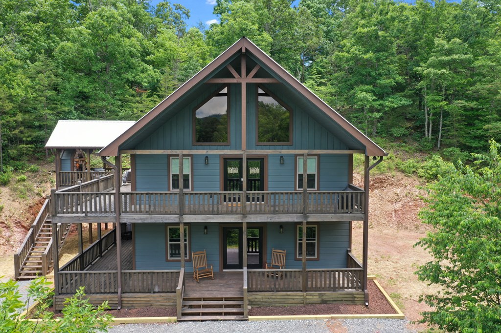 42 Old Jerusalem Road Morganton, GA 30560 - Photo 3 of 61 a view of a house with large windows and a small yard