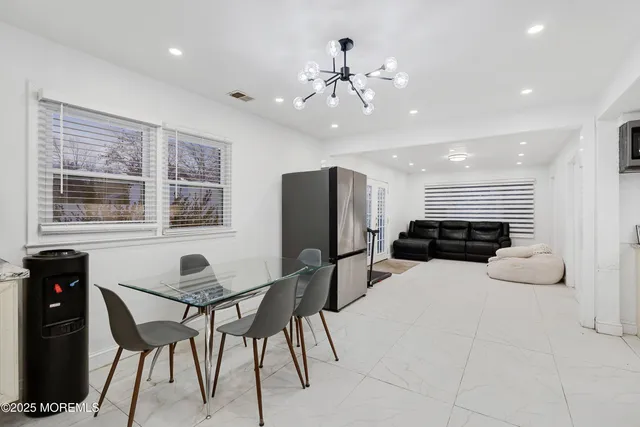 a outdoor kitchen with a table and chairs